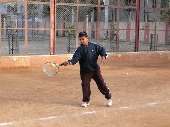 Young Abhiney Kumar playing tennis on clay court - where the journey began
